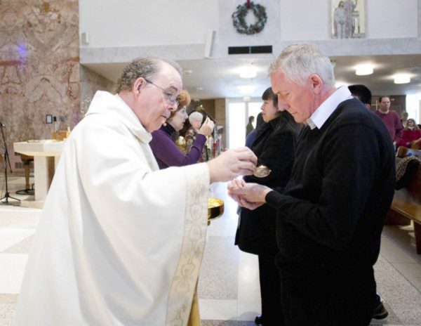 Stuart Heyes receives a gluten free communion wafer from Father Bob Clark during a service at the St. Cletus Catholic Church in LaGrange, Ill., on Sunday, Jan. 8, 2012.  (Corey R. Minkanic/for the Chicago Tribune) ORG XMIT: . ...OUTSIDE TRIBUNE CO.- NO MAGS,  NO SALES, NO INTERNET, NO TV, NEW YORK TIMES OUT, CHICAGO OUT, NO DIGITAL MANIPULATION...